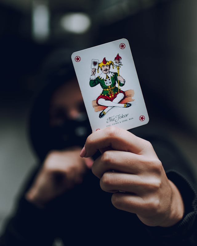Person holding a Joker card